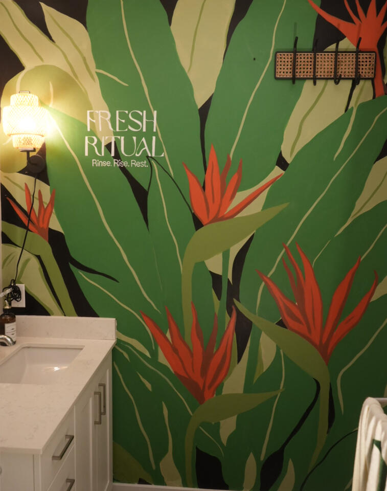 Fresh Ritual Mural, Ottawa 2025 Tropical botanical mural featuring large green leaves and red bird-of-paradise flowers in a restaurant interior.