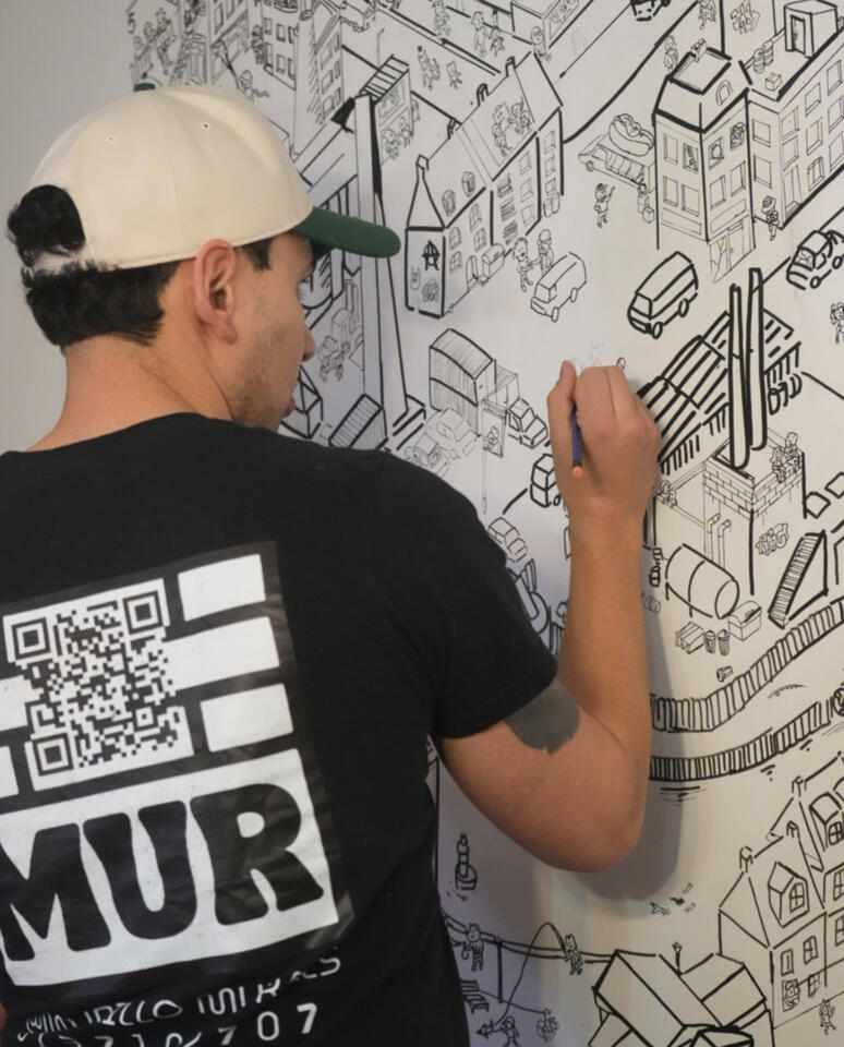 Crime City Mural - Ottawa Artist painting a detailed black-and-white cityscape mural featuring buildings, streets, and urban architectural elements in Ottawa.